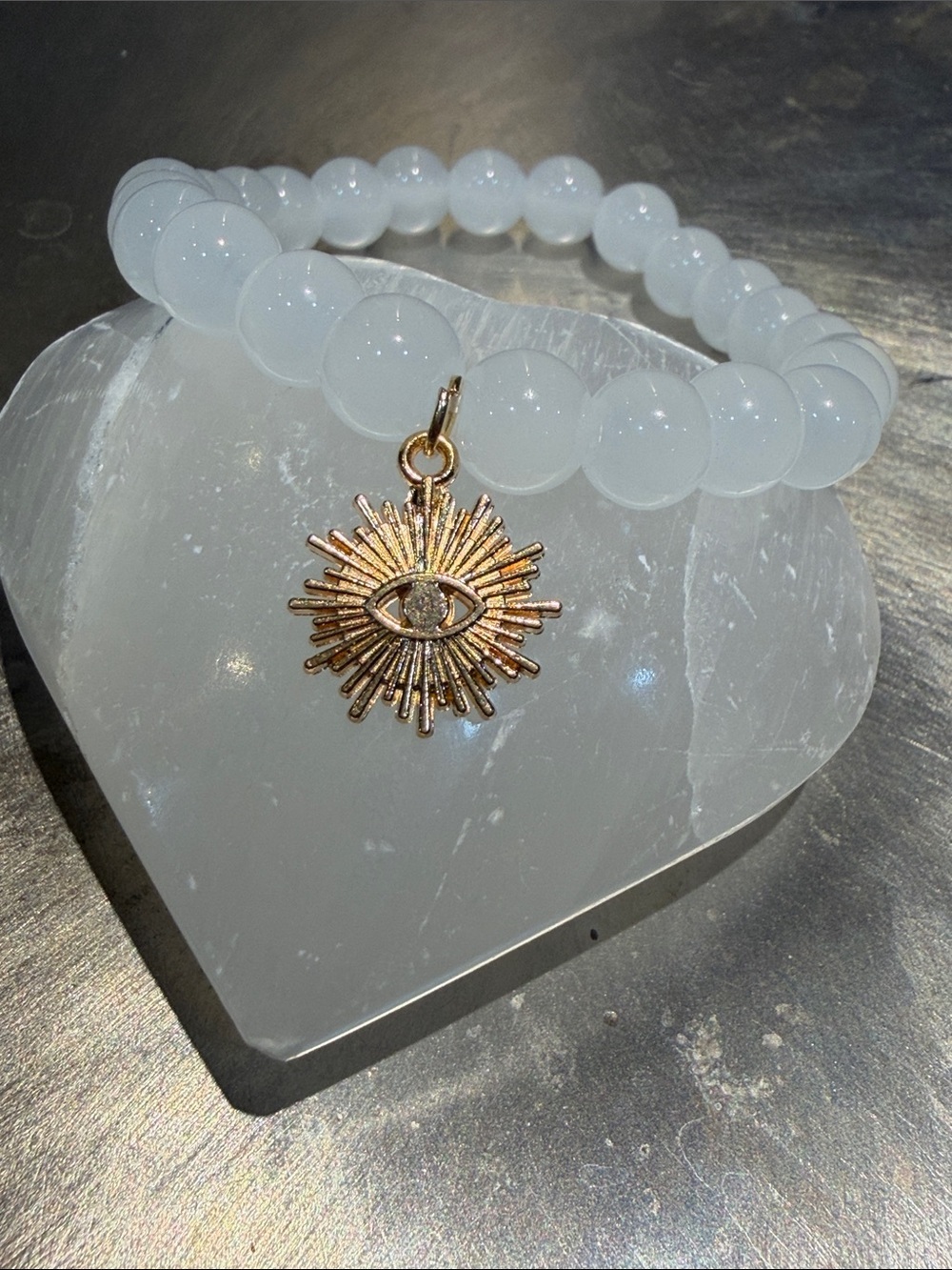 White Beaded Bracelet with Gold Sunburst Eye Charm